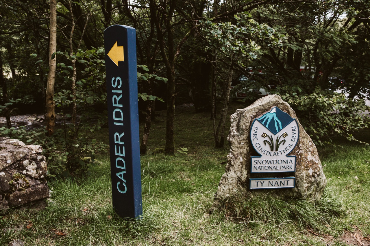 Cader Idris sign stands along Snowdonia National Park emblem
