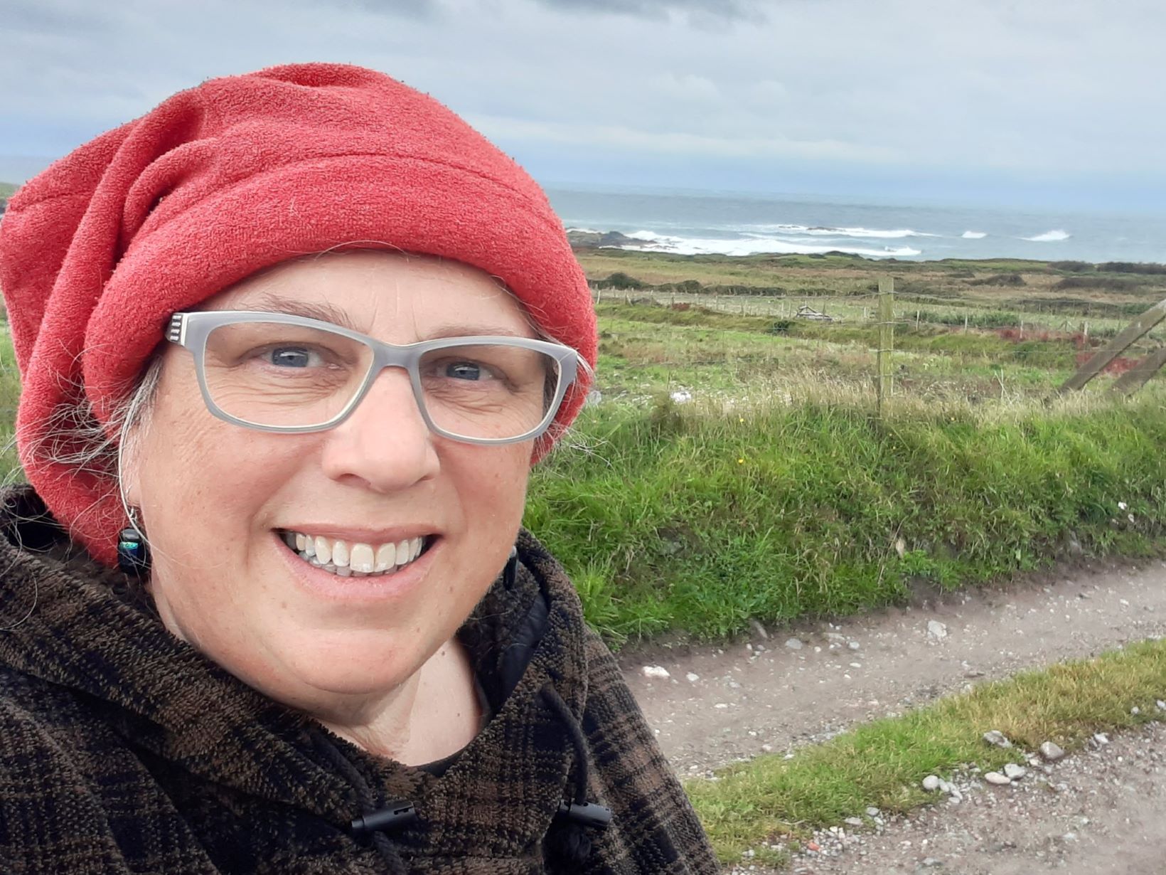 Selfie of Mair Tomos Ifans with sea in the background.