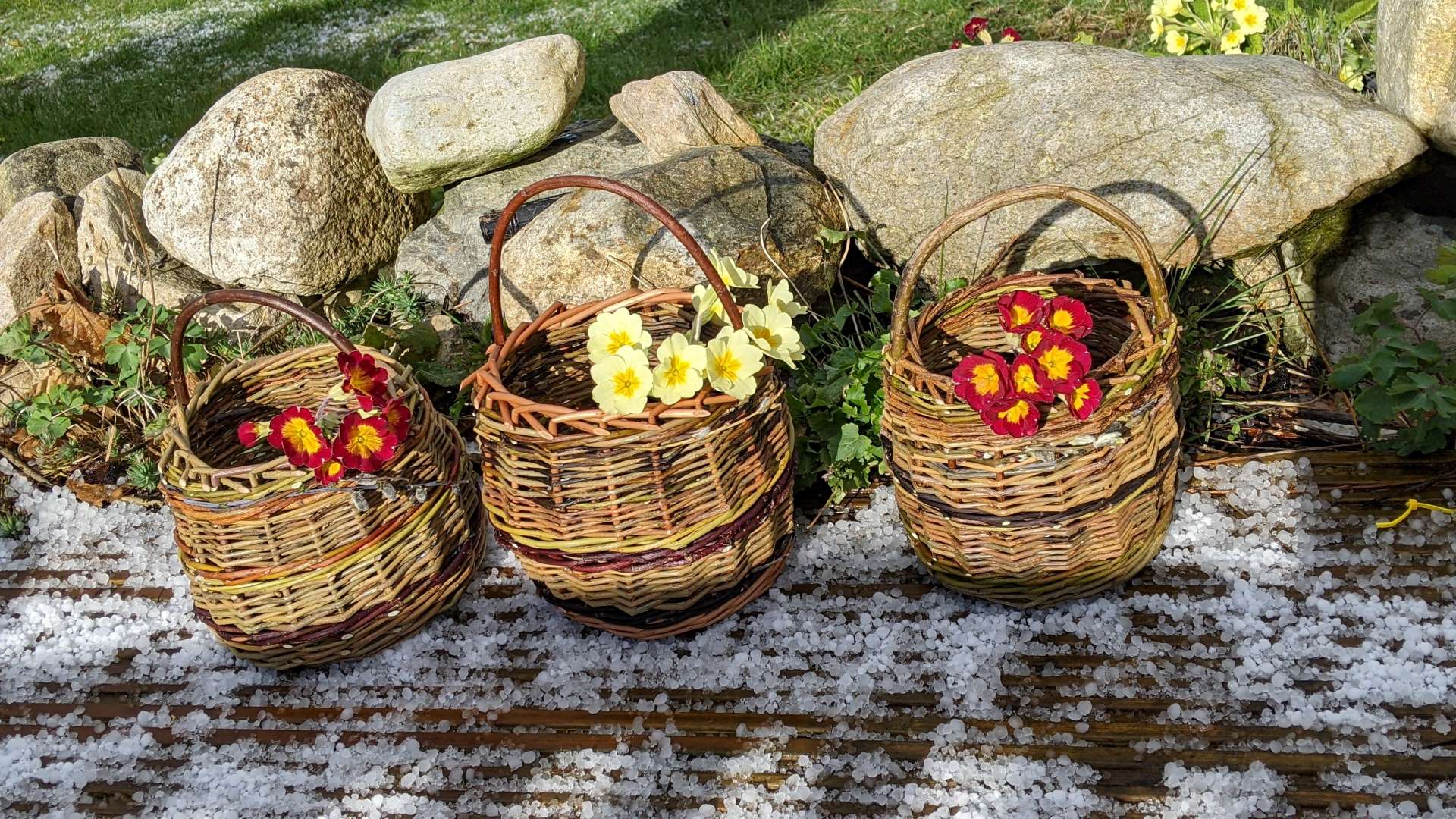 Three weaved baskets containing flower.
